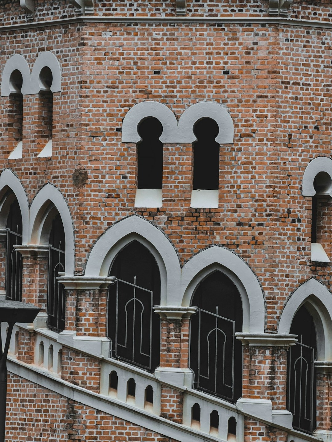 Ornate brick building with arched windows and Islamic patterns.